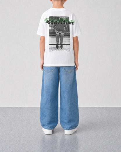 STORITIME® READ More Books Tee in Optic Gecko, back on-body view with relaxed blue denim.